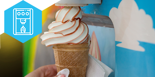 Ice cream machine dispensing vanilla swirl ice cream into a cone